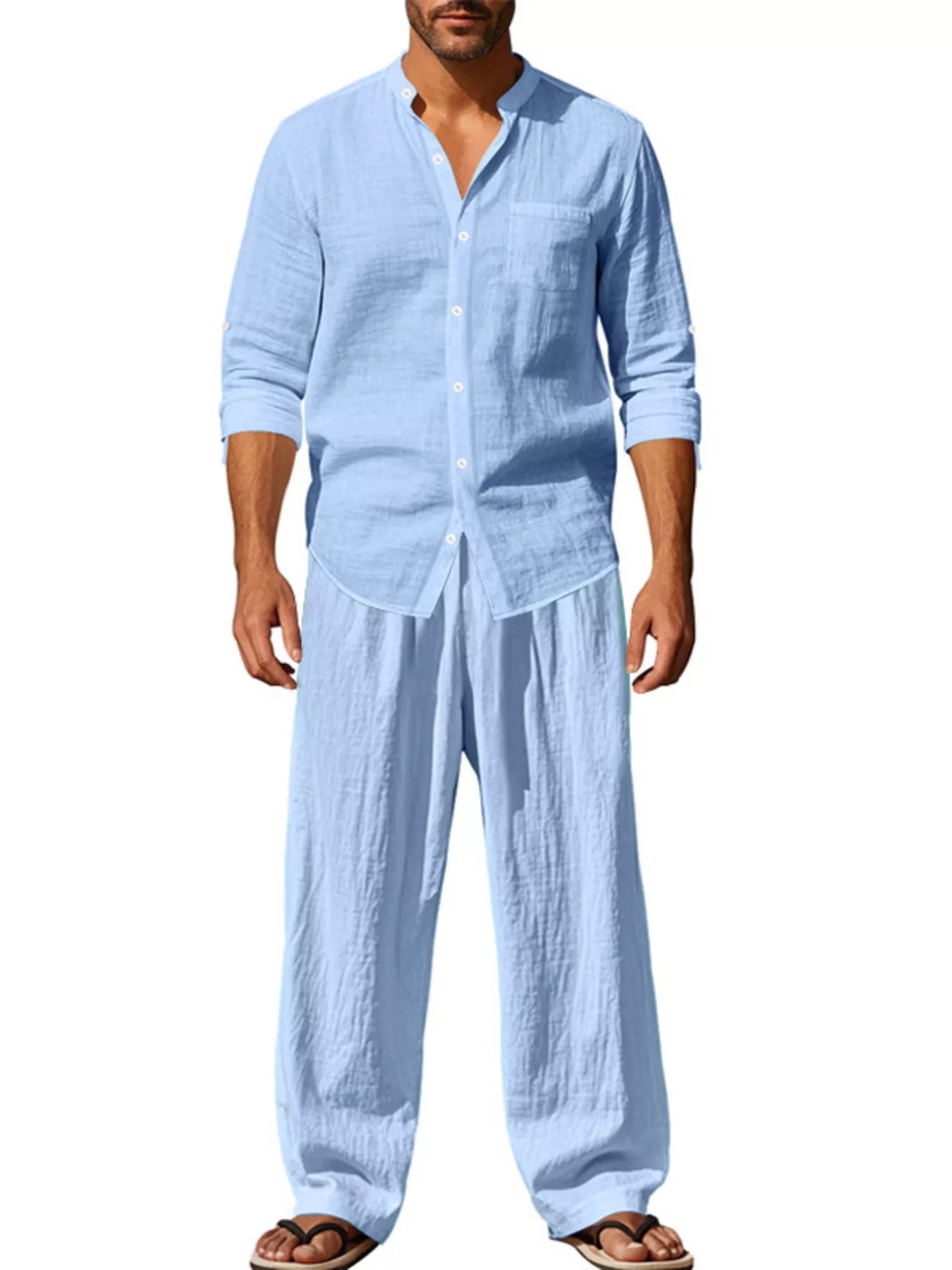 Trendbye Man wearing a light blue linen shirt and pants on a white background