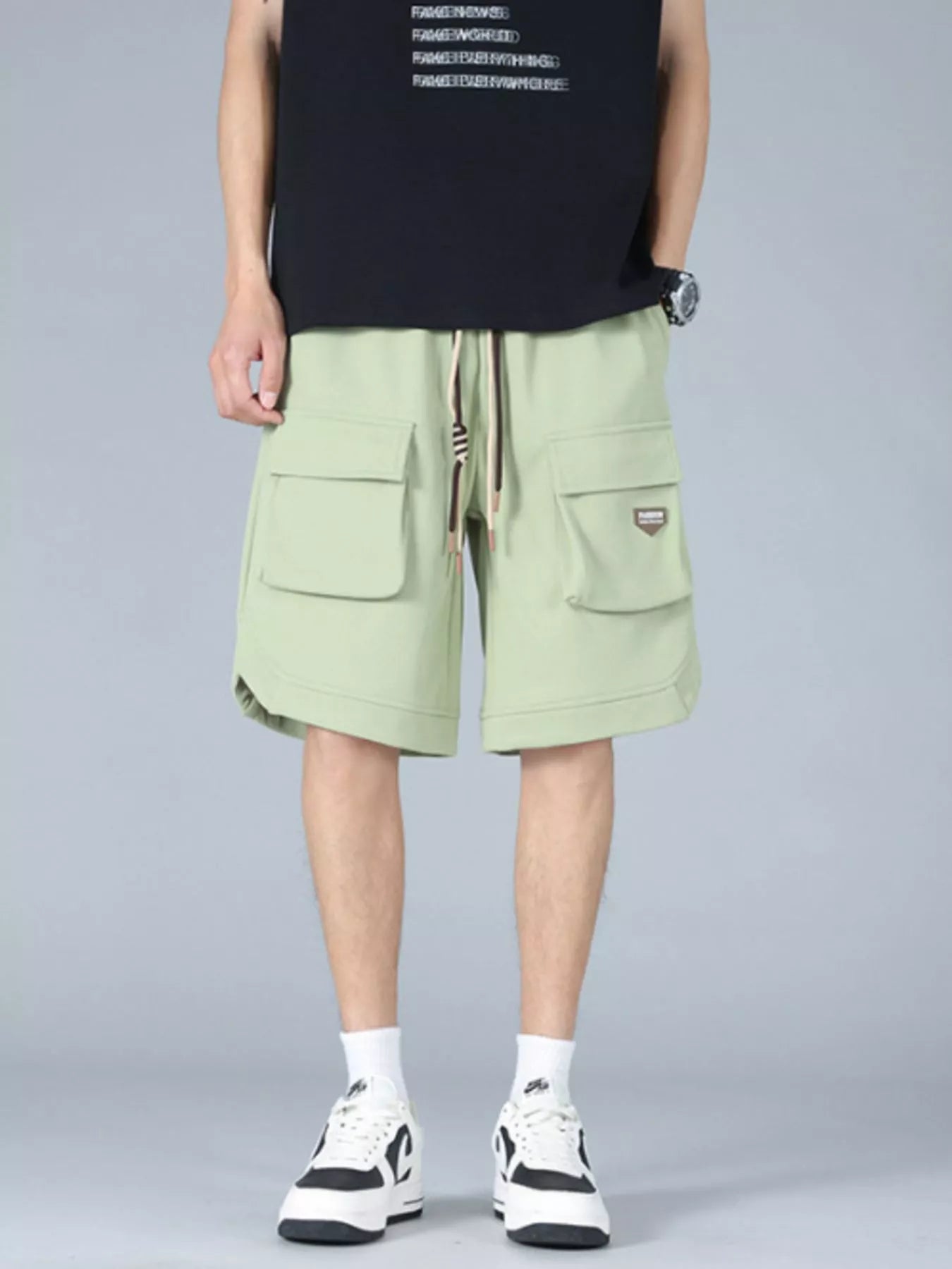 Trendbye Men's wearing light green cargo shorts 